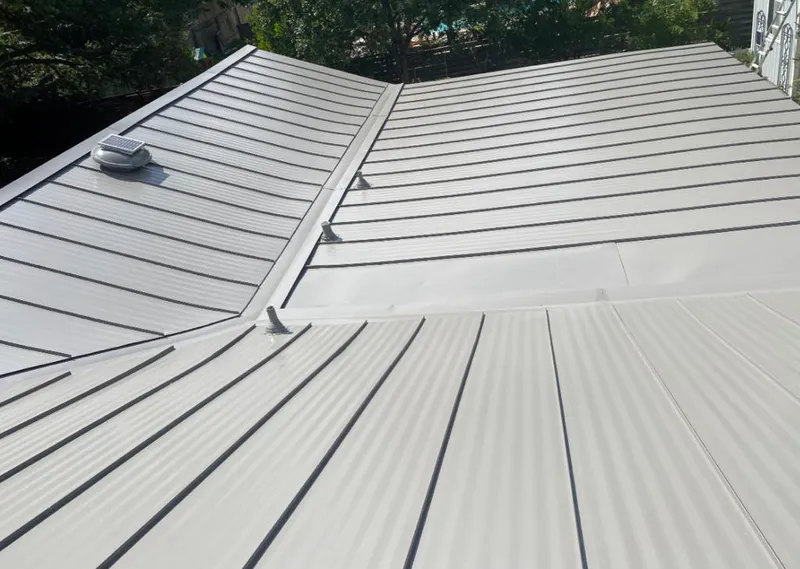 Solar attic fan installed on a metal roof for Roof Ventilation in Southlake